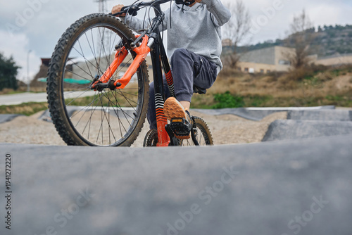 Close up of child riding bicycle on pump track