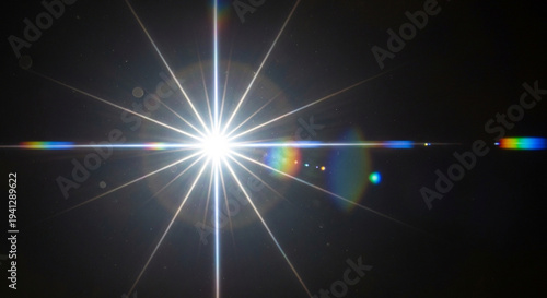 Bright light starburst effect with lens flare on dark background creating a radiant beam of light