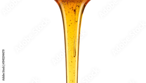 Close-up of golden liquid cascading downwards with a smooth, glossy texture on black