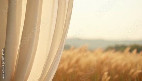 Light cream fabric hangs softly revealing golden grassy field, distant hills. Gentle breeze moves tall dry plants creating peaceful outdoor atmosphere. Soft warm sunlight illuminates natural
