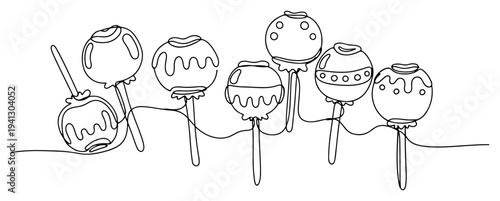 Minimalist continuous line drawing of sweet decorated candy apples on sticks