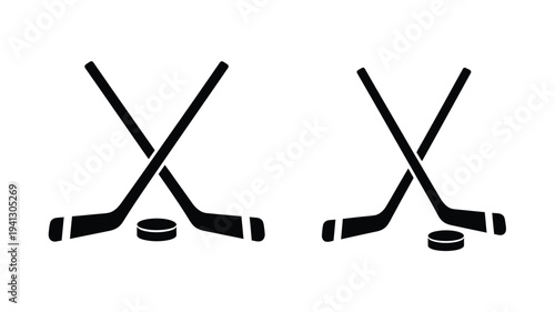 Two crossed hockey sticks and a puck in stark silhouette