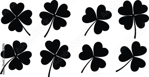Collection of eight black four leaf clover silhouettes on white background
