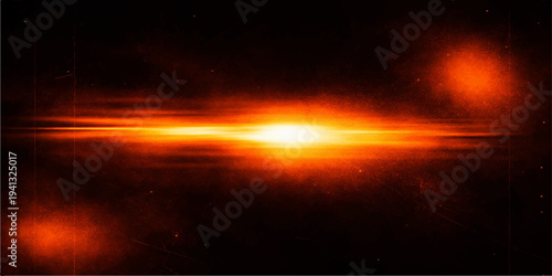 A dramatic orange sunset glows over the dark forest as beautiful firelight flickers in the evening twilight