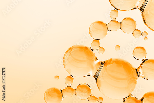 Abstract golden oil molecules floating on warm background. 3D render of luxury cosmetic serum or vitamin liquid with glossy transparent spheres, molecular structure, and copy space.