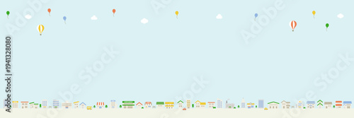 空にコピースペースのある街並み風景　 風船と雲の横長イラスト