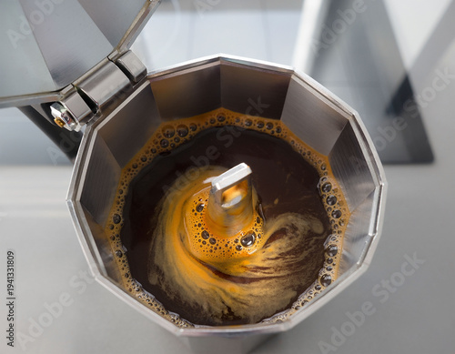 Freshly brewed coffee in italian moka pot seen from above