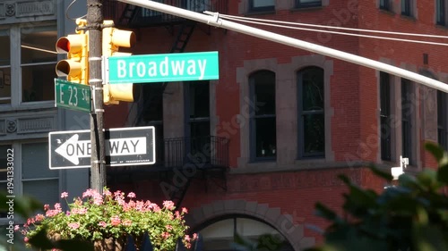 New York City Broadway street sign on Manhattan, United States. Urban road sign in american city. Traffic sign in Midtown. Building architecture in Flatiron district. Crossroad with 5 fifth avenue.