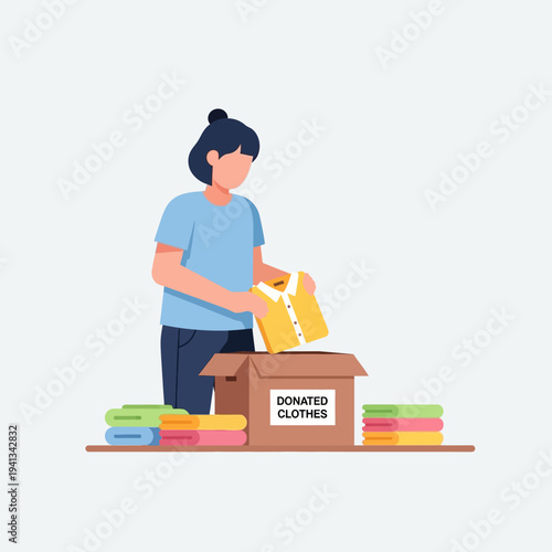 Woman packing donated clothes into a box for charity.