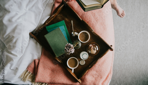 Cuadro en lienzo Wooden tray holds coffee cups, books, and flowers on a cozy bed