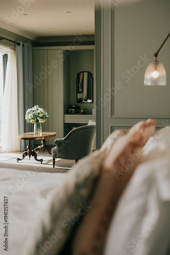 Fotografía Soft focus on cozy bedroom with muted green walls and vintage chair