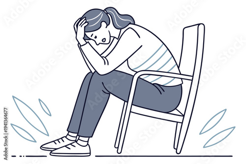 Overwhelmed stressed woman sitting alone on a chair with head in hands experiencing mental health issues