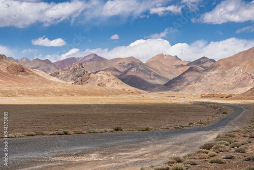 Colorful high-altitude mountain landscape view of road to Ak Baital pass on Pamir Highway, Murghab, Gorno-Badakhshan, Tajikistan