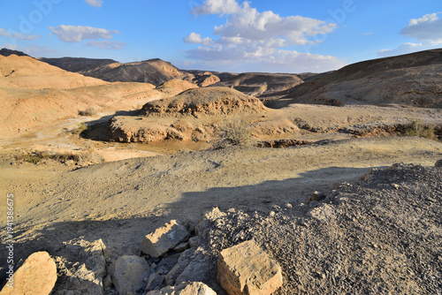 Photos Rocky desert landscape with hills and clouds in Negev desert