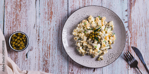 Savory salad with eggs, cheese, peas and chives on a plate on the table top view web banner