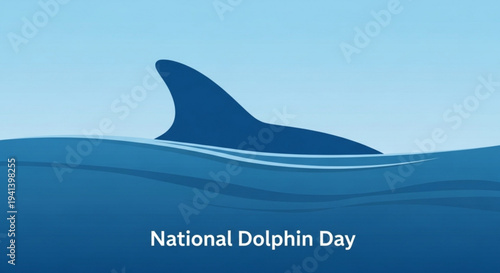 Dolphin fin breaks surface on national dolphin day with ocean waves and blue gradient background