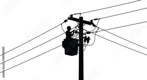 Black silhouette of an electrician working on a power line from a bucket truck, electrical utility worker repairing high voltage wires.