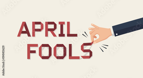 Hand in suit sleeve pulling april fools text with playful gesture on beige background