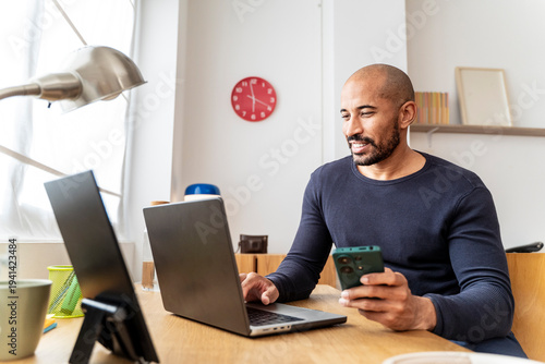 Mid man working at home office celebrating course completion