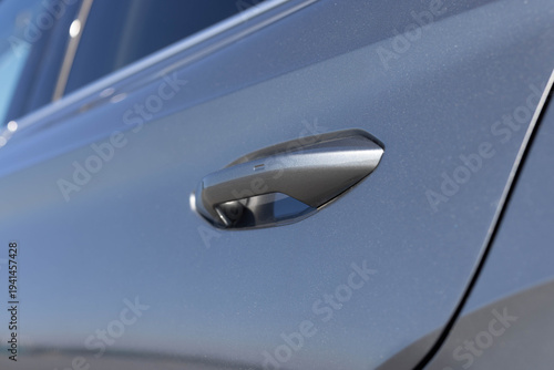 Keyless entry car door handle with keyless go touch sensor. Automatic opening of a car door without a key. Car door handle. Access button. Exterior design of a new electric luxury car