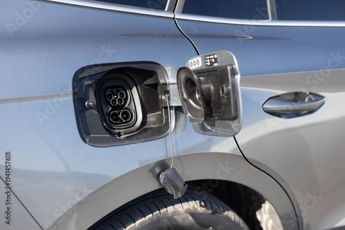 Type 2 CCS plug port on electric vehicle. DC - CCS type 2 EV charging connector at EV car. Fast charging socket type 2 combo electric car. Eco friendly alternative energy green environment concept