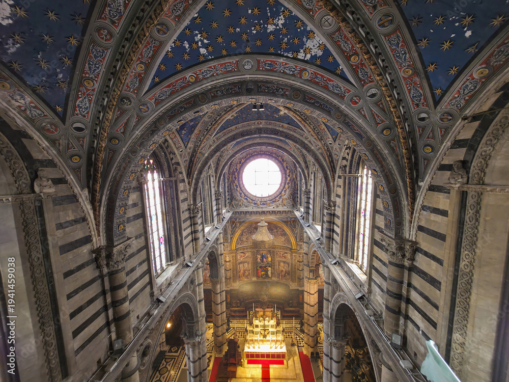 Fototapeta premium High Angle View of Siena Cathedral Interior from Gate of Heaven (Porte del Cielo), Italy. Majestic Gothic Architecture with Striped Marble Columns, Vaulted Ceiling and Rose Window in Tuscany
