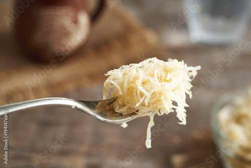 Tableau sur toile Fermented cabbage or sauerkraut on a fork