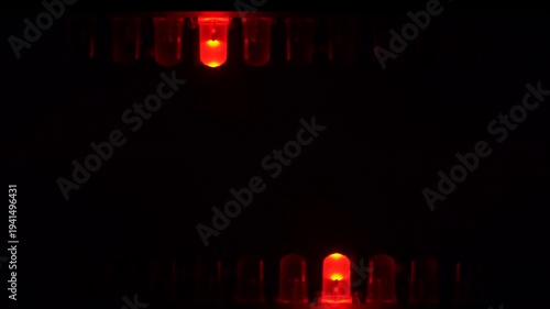 Chasing running light on red LED line in dark environment.