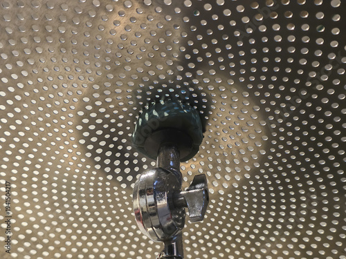 Powerful spinning machine with rotating beater creates dynamic motion blur. industrial metal equipment inside perforated steel drum represents technology and force