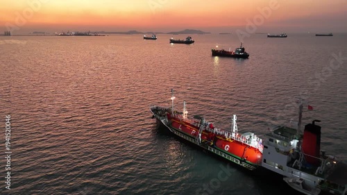4K Aerial view a lot of LPG tanker ships anchored at sea during golden sunset