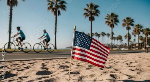 American flag on the beach with cyclists and palm trees