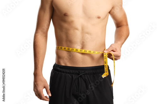 Cuadro en lienzo Young man with naked torso measuring his waist