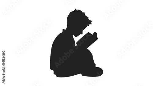 Silhouette of a Young Boy Reading a Book Intently