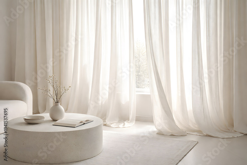 A serene and modern living room a round coffee table and white curtains