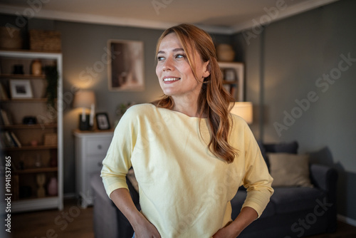Schilderij op canvas Smiling young woman looking away feeling content at home
