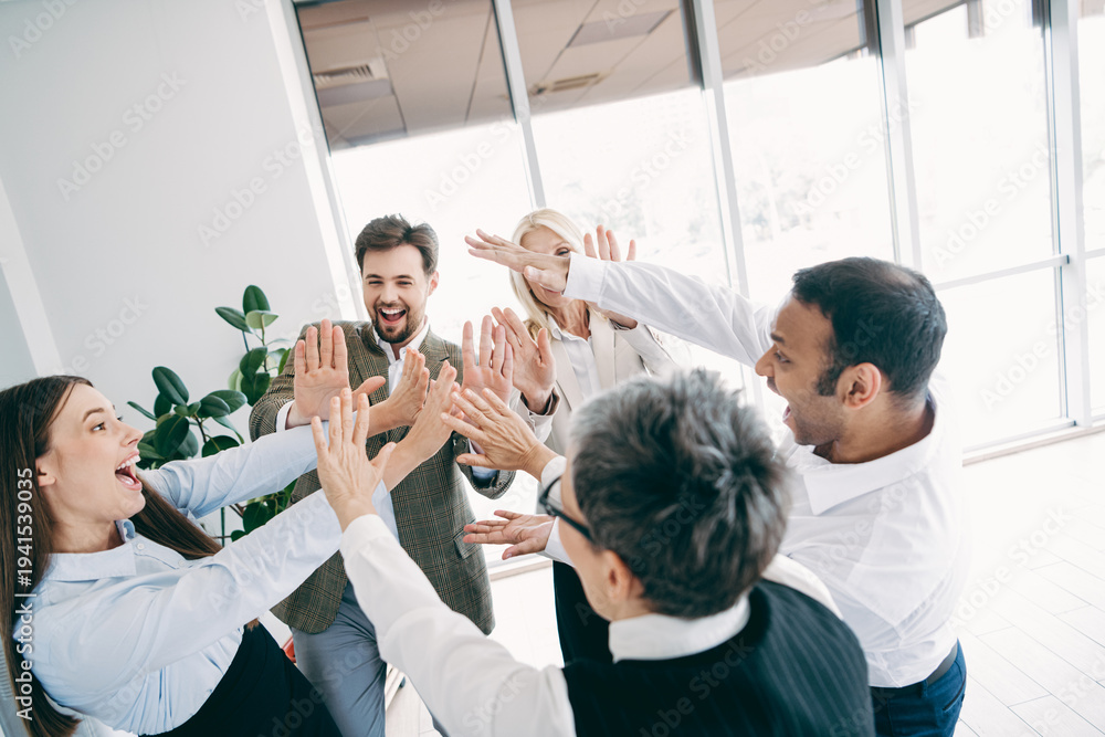 Obraz premium Dynamic office team celebrates success in a vibrant professionals' meeting space