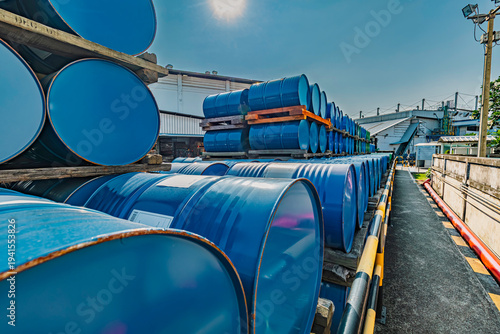 Blue barrel In the warehouse, 200-liter chemical barrels are arranged on wooden pallets and waiting for delivery. Transportation technology