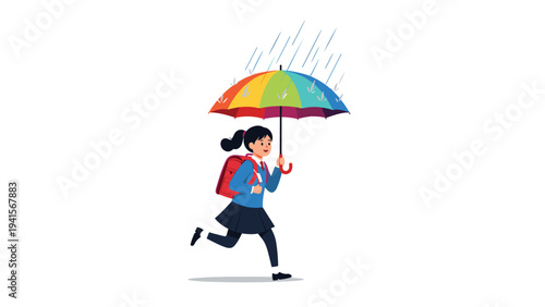 Young schoolgirl running through the rain while holding a colorful rainbow umbrella and wearing a blue uniform with a backpack.