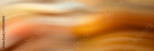 Warm flowing abstract swirls with vibrant orange and brown hues creating a dynamic soft visual effect