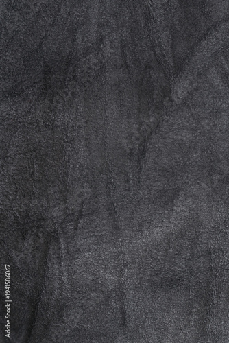Crumpled black suede textured vertical background