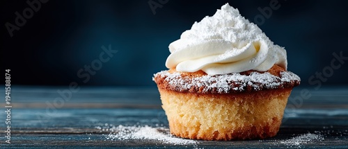 Vanilla cupcake with powdered sugar and vanilla icing