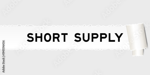 Ripped gray paper background that have word short supply under torn part