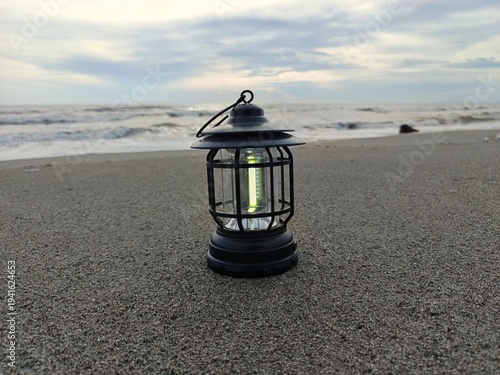 Lantern on beach during sunset Ramadan Kareem concept