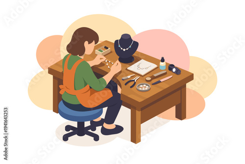 Jeweler working on a necklace at a wooden workbench.