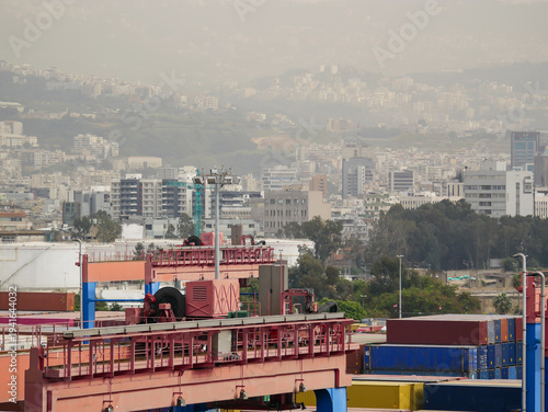 Container terminal with cargo cranes and stacked shipping containers at Port of Beirut, Lebanon.