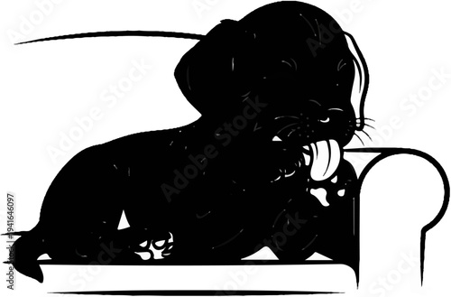 Black puppy with tongue out resting on a sofa