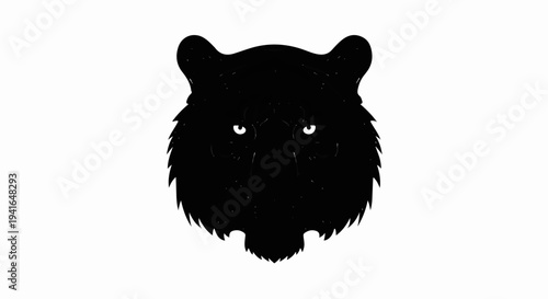 Black silhouette of a fierce tiger's face with bright white eyes