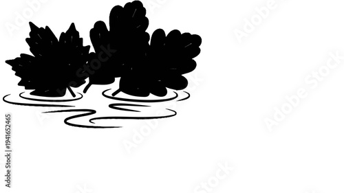 Black leaf shapes floating on rippled water