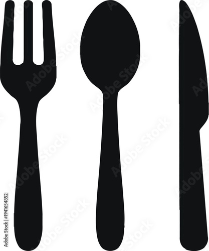 Set of silver kitchen utensils including spoon fork and knife on dining table