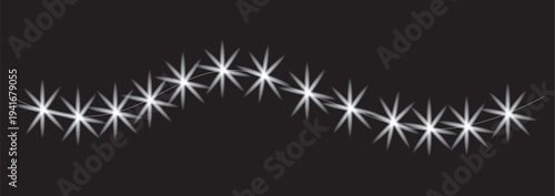Sparkling white lights on black background forming a diagonal line